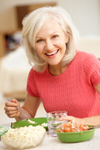 Picture of smiling woman getting ready to eat