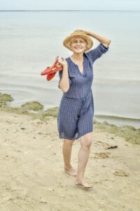 picture of mature woman walking on the beach