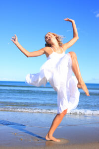 Picture of woman jumping on the beach