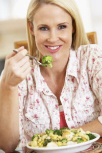 picture of woman with food on a fork