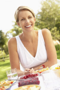 Picture of woman sitting outside with some food