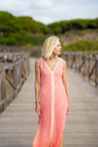 Picture of woman in a pink dress looking over her shoulder