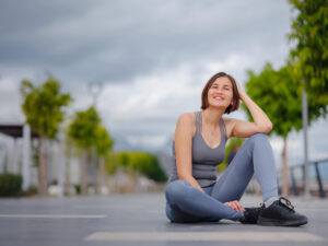 Picture of woman sitting on the ground outside