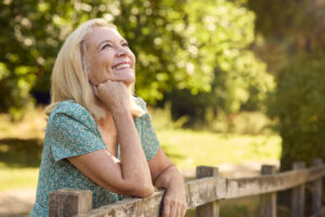 Picture of smiling mature woman looking up