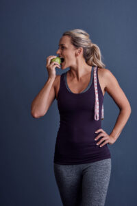 Picture of woman taking a bite of apple