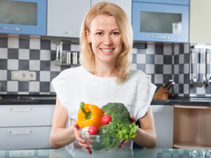 Picture of woman holding a bowl of vegetables