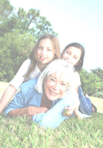 Picture of grandmother playing outside with grandchildren