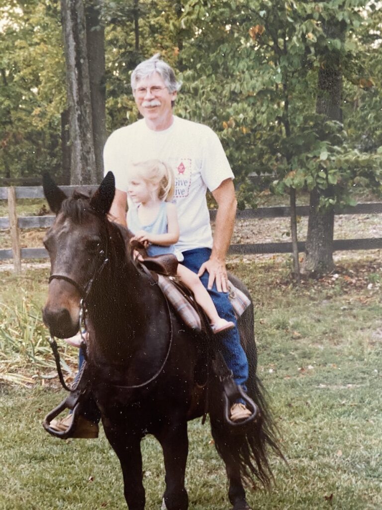 Picture of grandfather on horseback with granddaughter