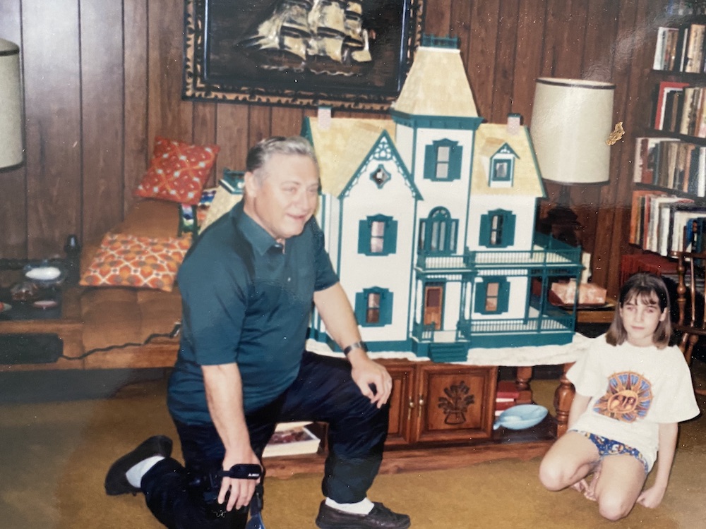 Picture of grandpa and granddaughter with dollhouse