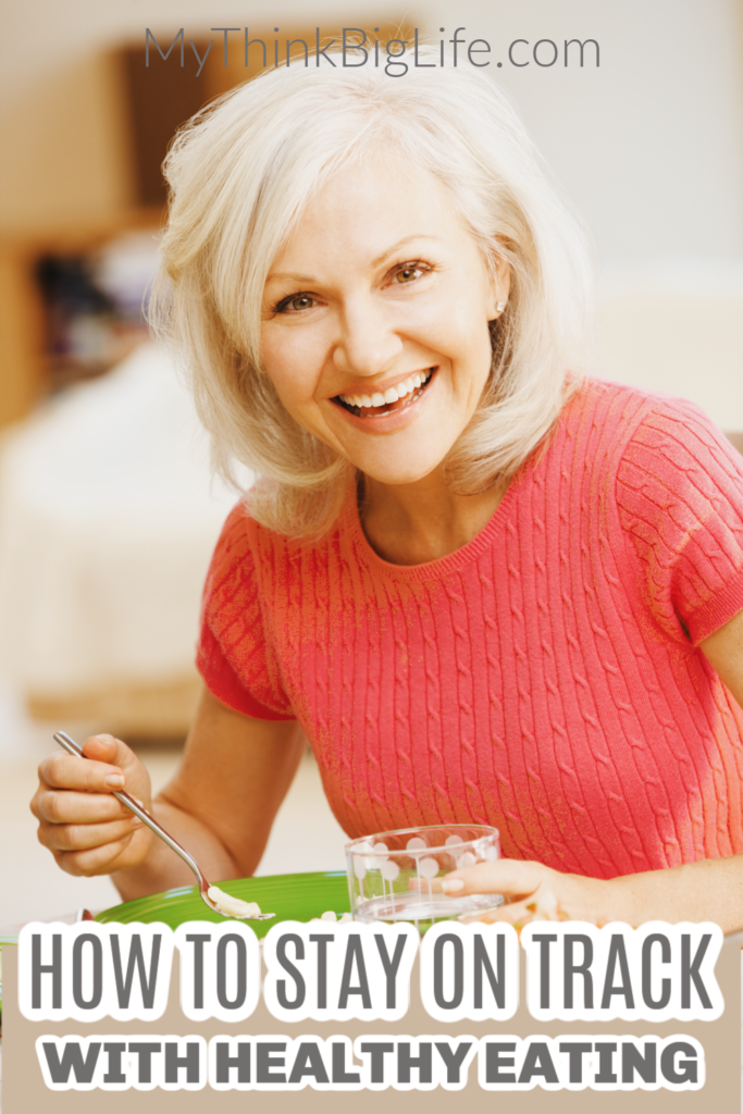 Picture of smiling woman getting ready to eat with the words: how to stay on track with healthy eating