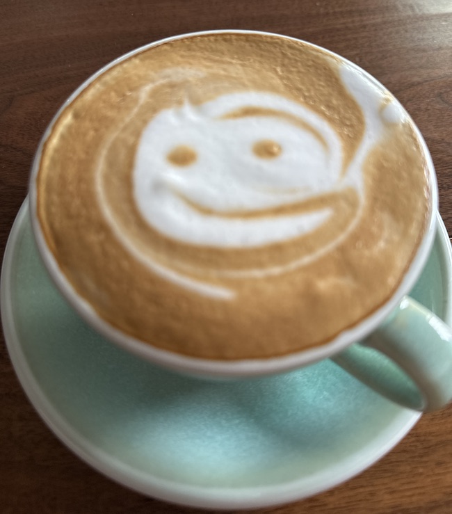 Picture of cup of coffee with smily face in the foam
