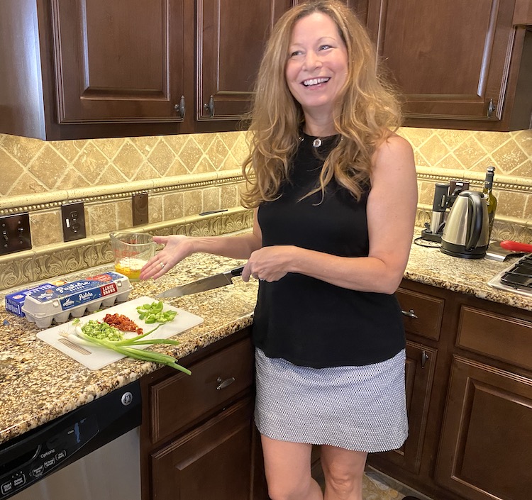 Picture of author Sara in a kitchen preparing food