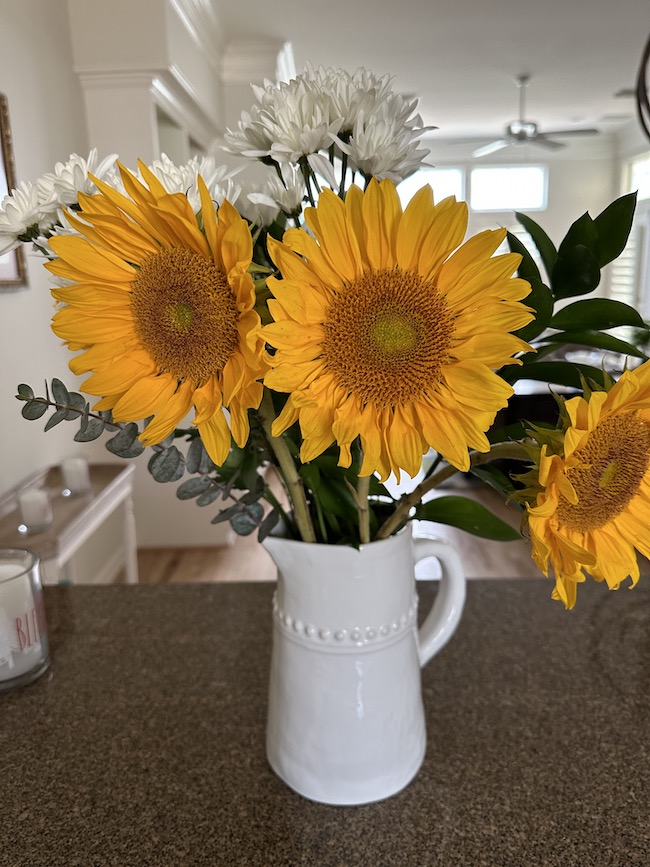 Picture of sunflowers in a white vase
