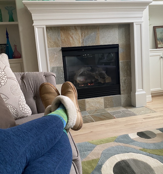 Picture of feet in slippers in front of the fireplace