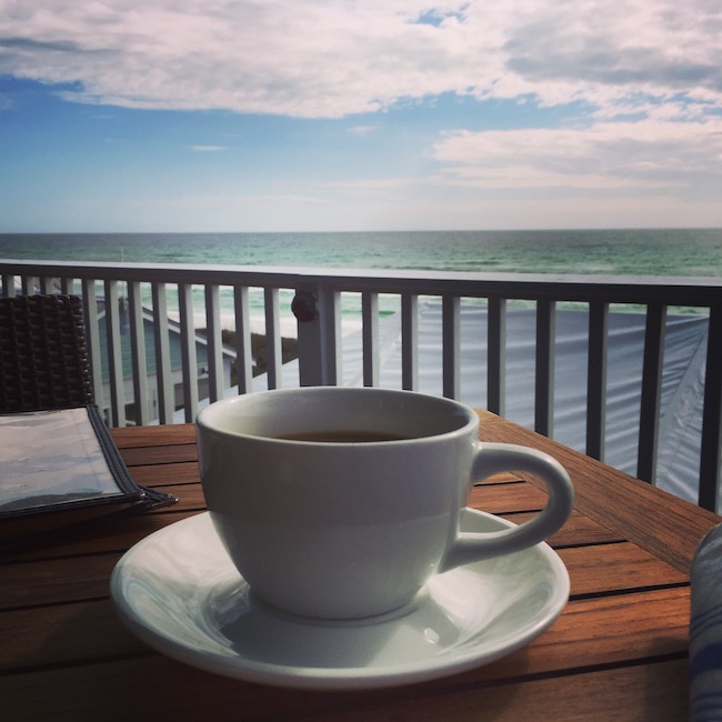 Picture of coffee with ocean in the backgroun
