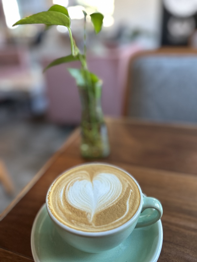 Picture of cup of coffee with heart made of milk