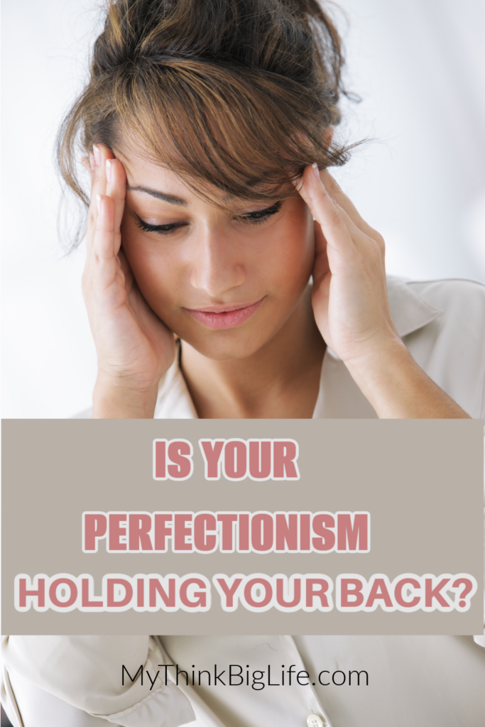 Picture of woman holding her head with the words: is your perfectionism holding you back