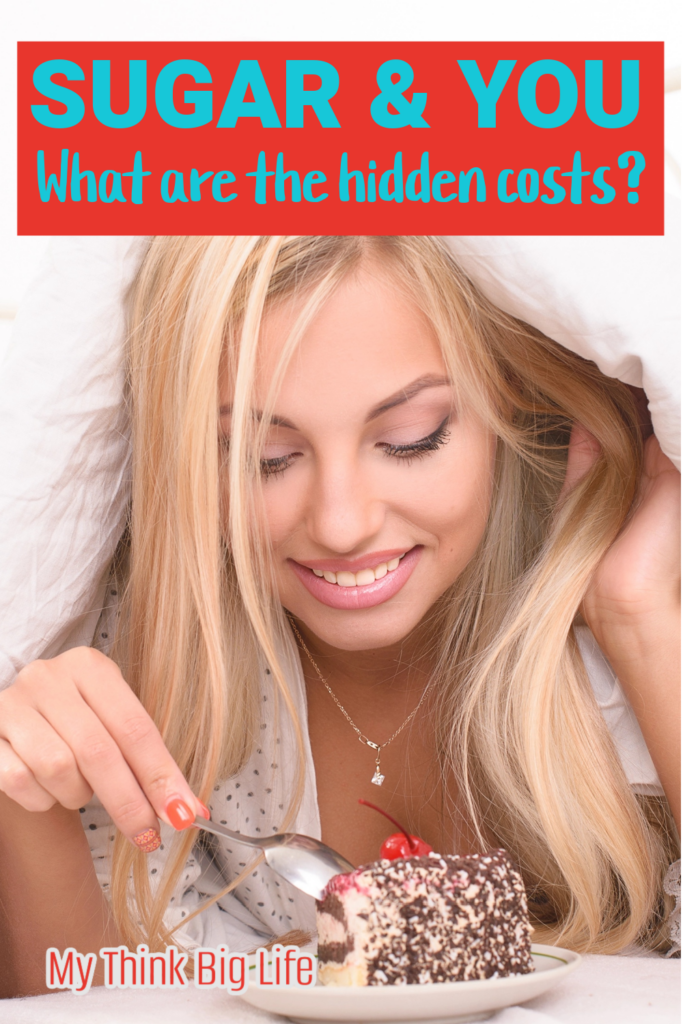 Picture of woman under the covers in bed eating a piece of cake with the words: Sugar and you. What are the hidden costs?